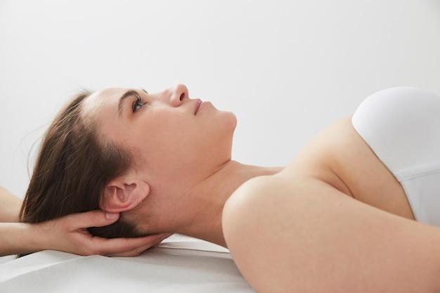 young woman lying down and looking upwards in a peaceful setting