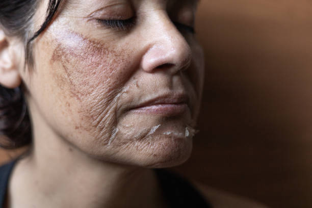 Woman with artistic facial makeup looking thoughtful